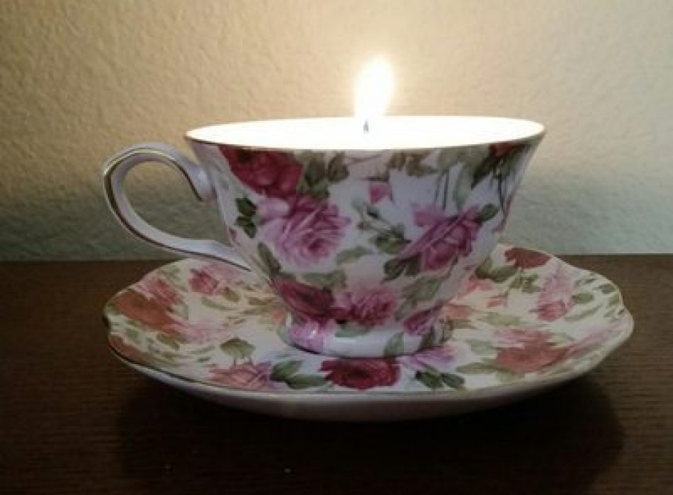 Lit candle in a teacup
